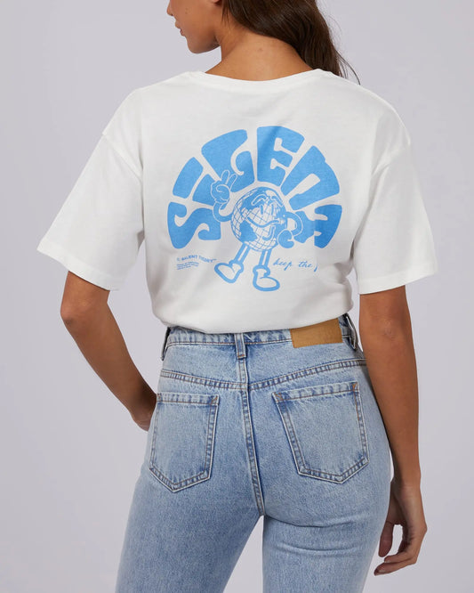 Person wearing a white t-shirt with blue graphic design on the back, standing against a plain background.