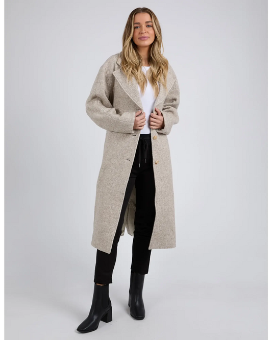 Woman wearing a beige long coat on a white background