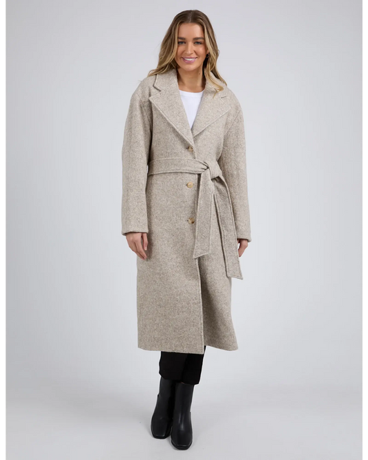 Woman wearing a beige coat on a white background