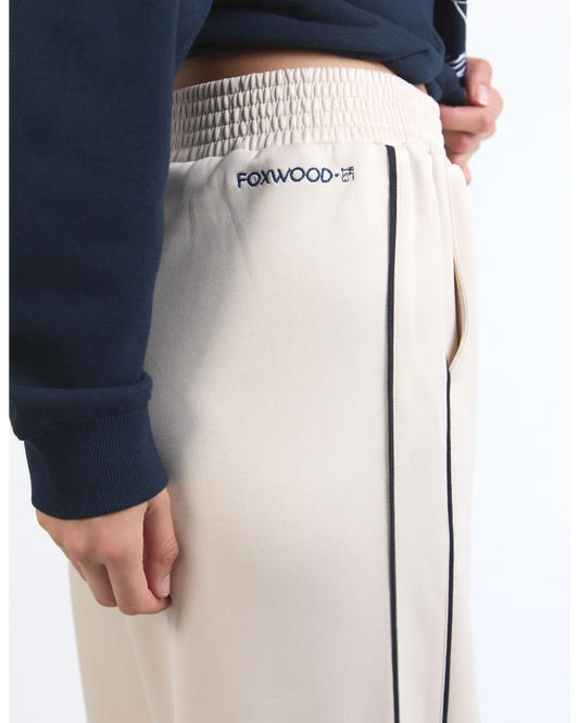 Beige pants with 'FOXWOOD' logo on a white background