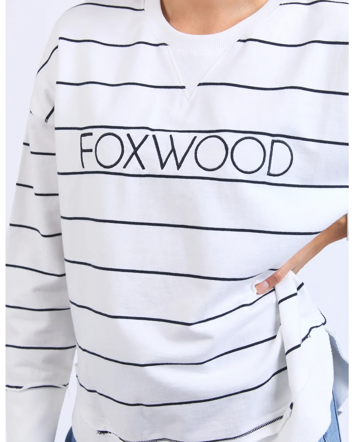 White sweatshirt with black stripes and 'FOXWOOD' text on a white background