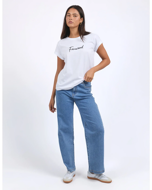 Woman wearing a white t-shirt and blue jeans on a white background