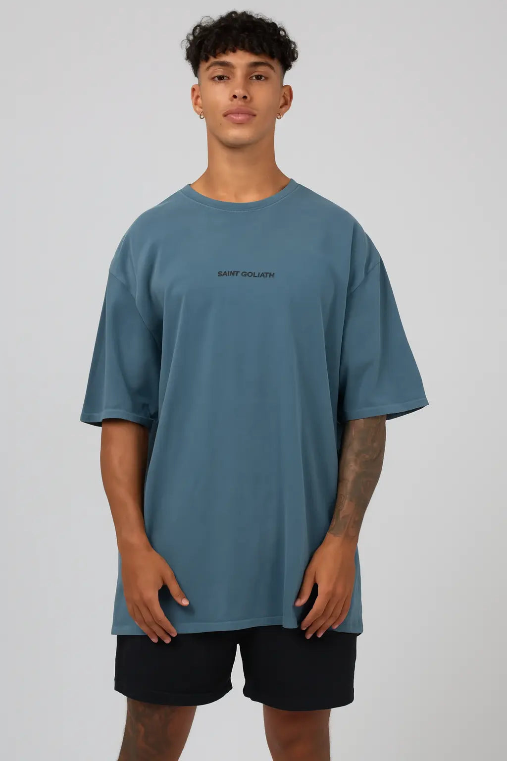 Person wearing a blue t-shirt with text on a plain background