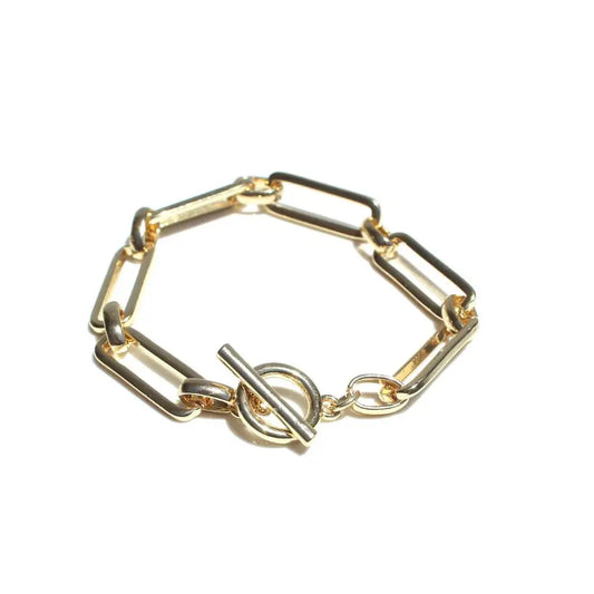 Gold bracelet with geometric links on a white background