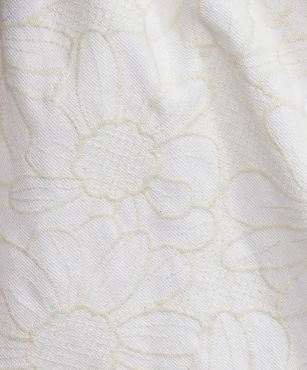Close-up of textured white fabric with a subtle pattern