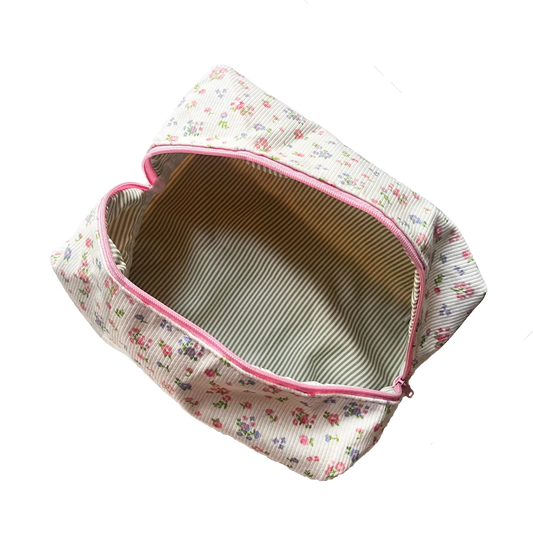Floral-patterned pouch with pink zipper on a white background. Buttermilk Grace Carry All Bag Forget-Me-Not - The Rose Edit
