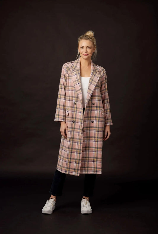 Woman wearing a plaid coat on a black background
