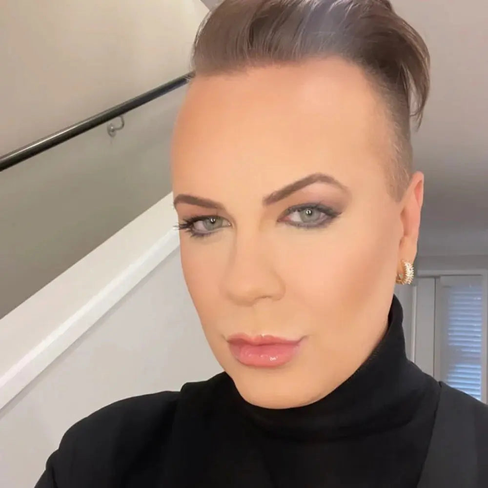Woman with styled hair and makeup wearing a black turtleneck in an indoor setting. The Perfect Huggies Diamond - The Rose Edit
