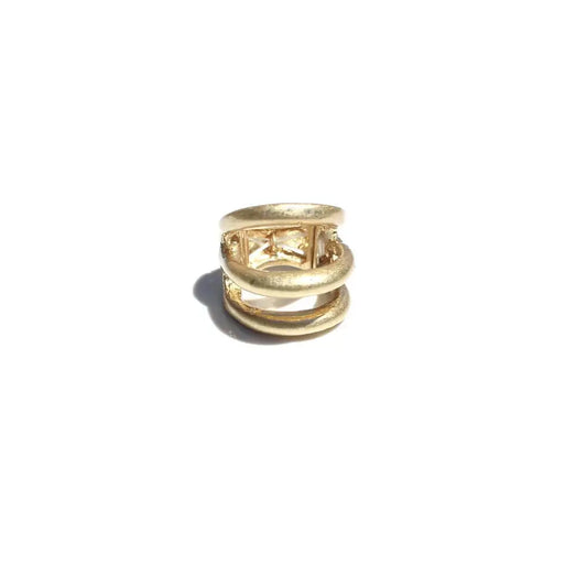 Gold ring with a textured design on a white background