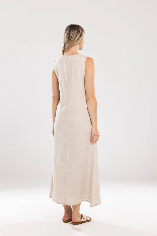 Woman wearing a beige sleeveless dress on a white background