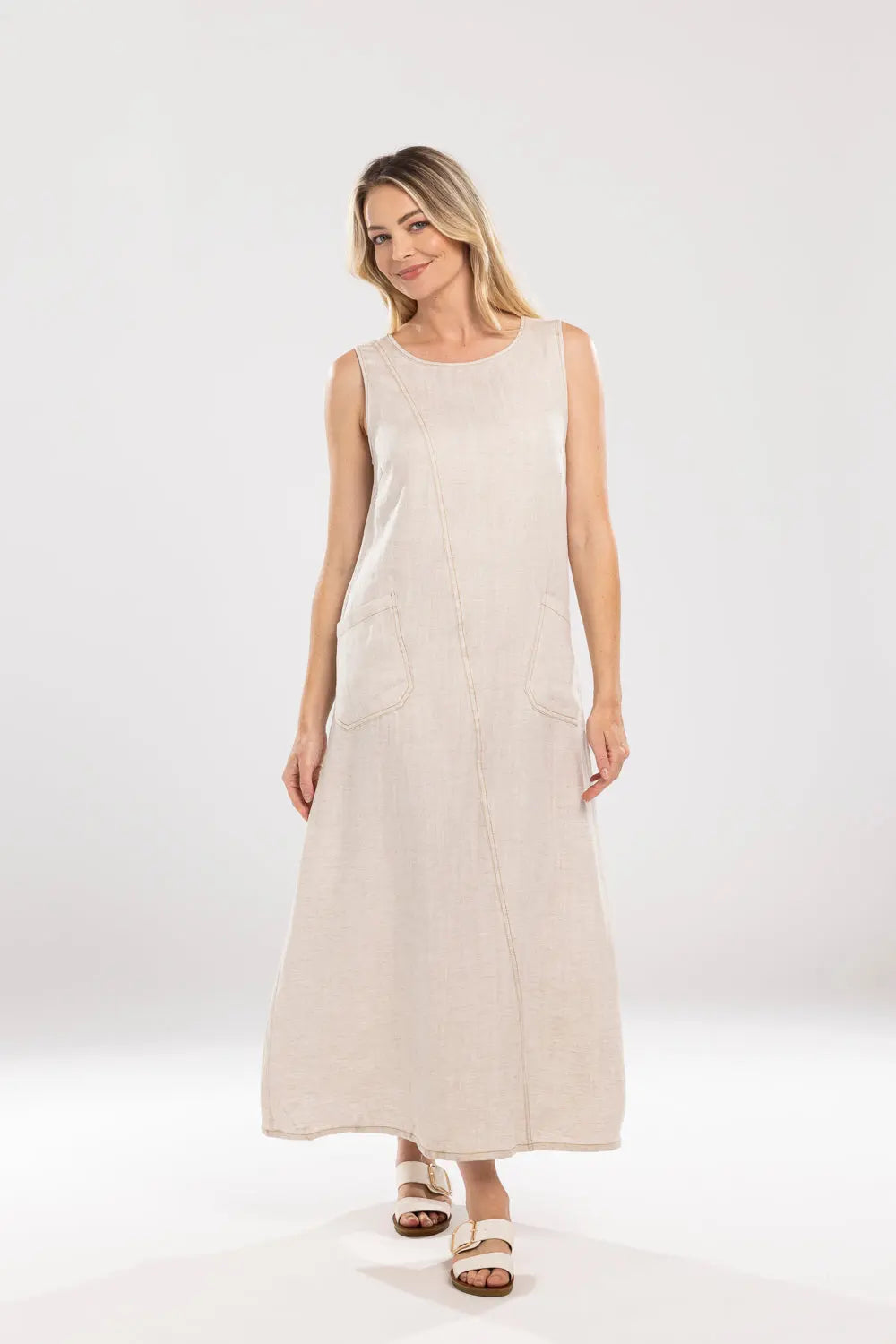 Woman wearing a beige sleeveless dress on a white background