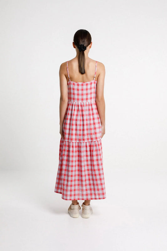 Woman wearing a red and white checkered dress on a white background