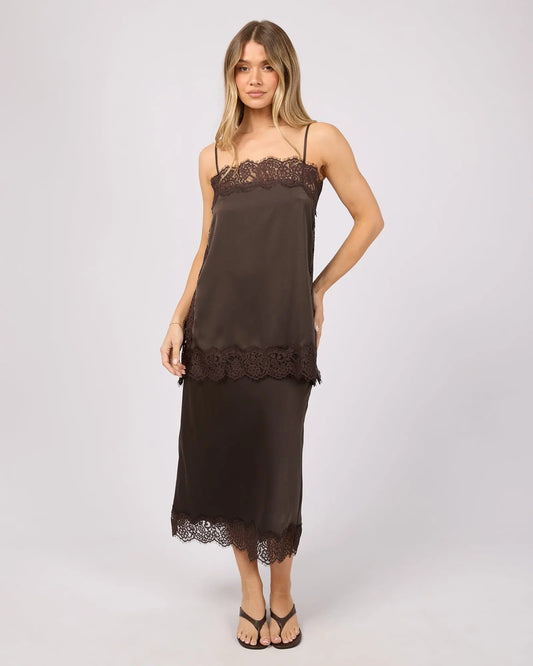 Woman wearing a brown slip dress with lace details on a white background. Hava Lace Skirt Coffee - The Rose Edit