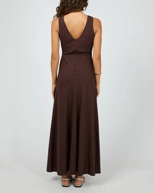 Brown dress with open back worn by a person on a white background