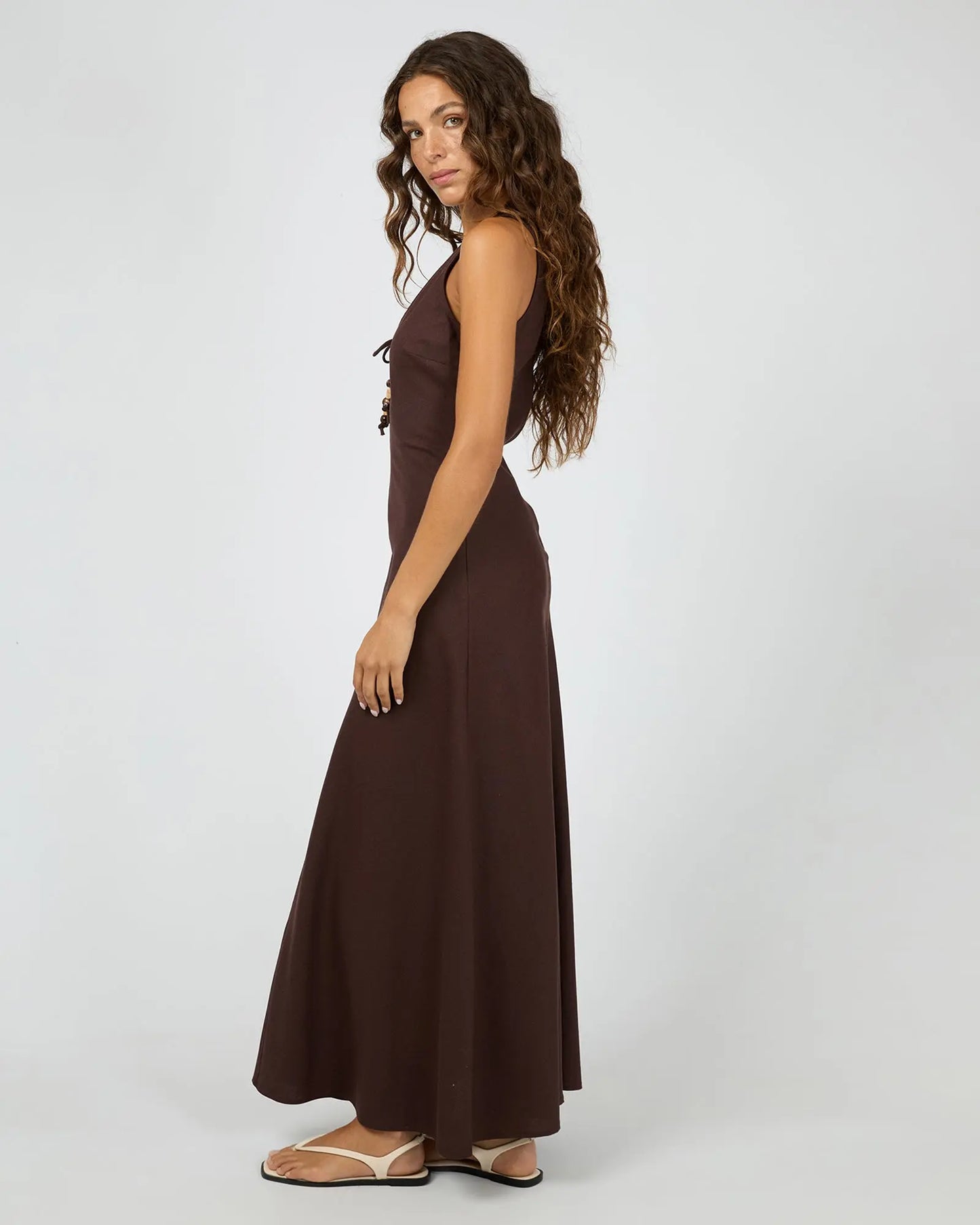 Woman wearing a brown dress on a white background