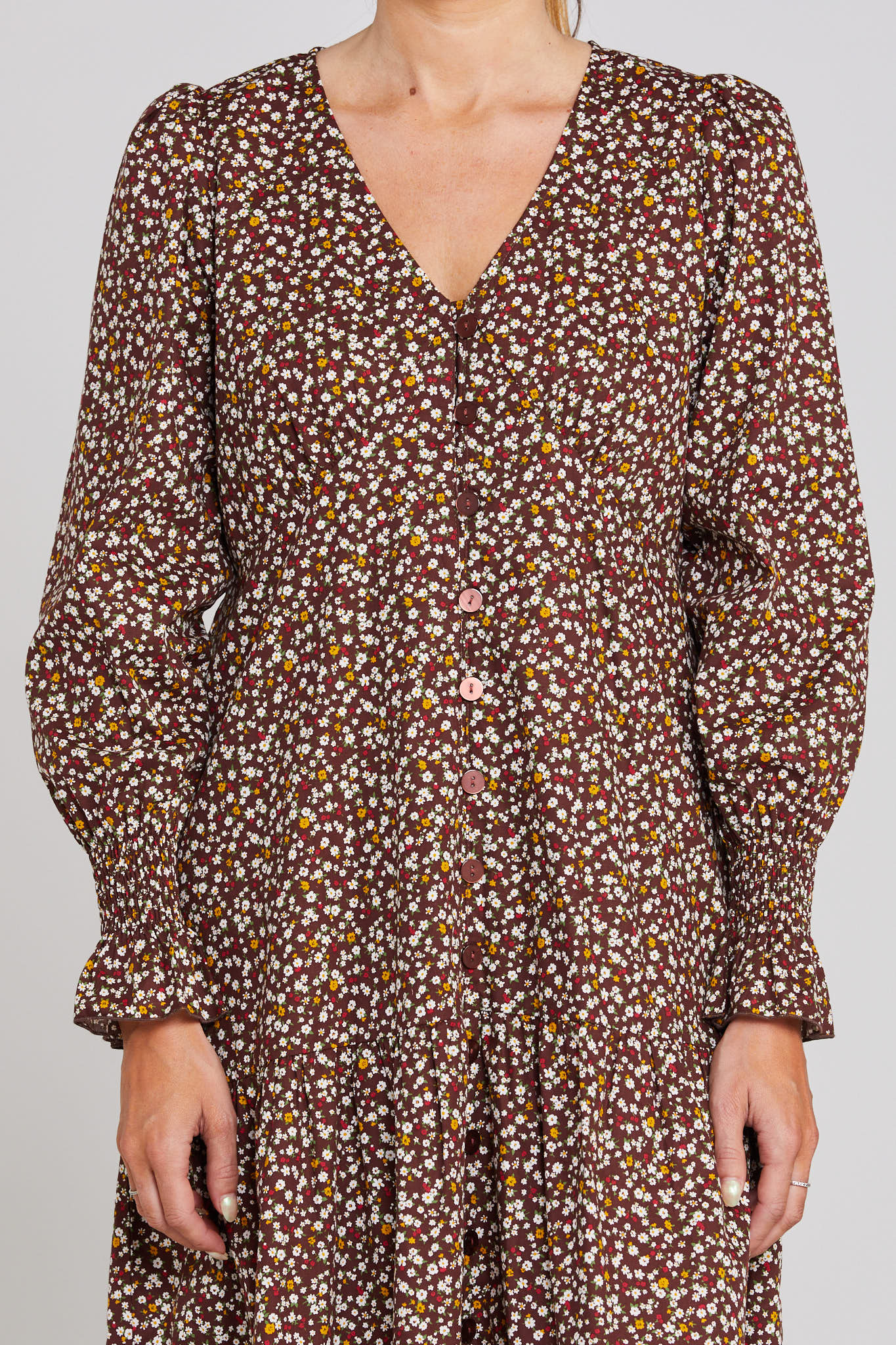 Floral patterned dress with long sleeves on a plain background