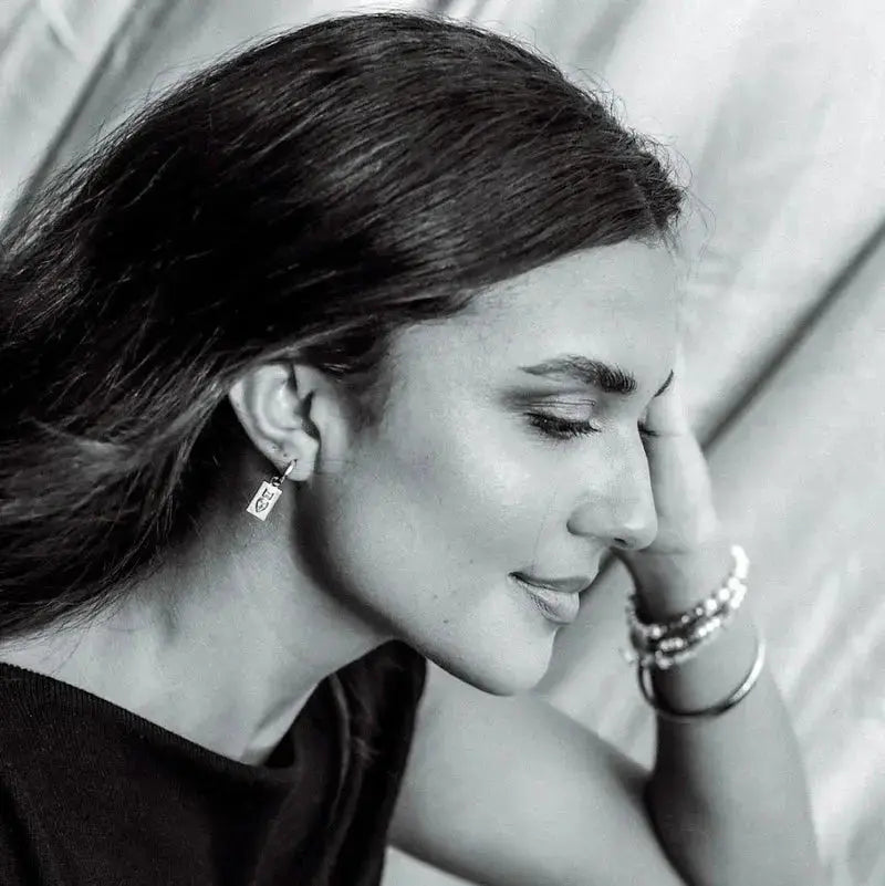 Woman wearing Dew Drop earrings by Queen of the Foxes — everyday gold jewellery from The Rose Edit
