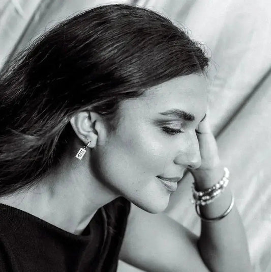 Woman wearing Dew Drop earrings by Queen of the Foxes — everyday gold jewellery from The Rose Edit