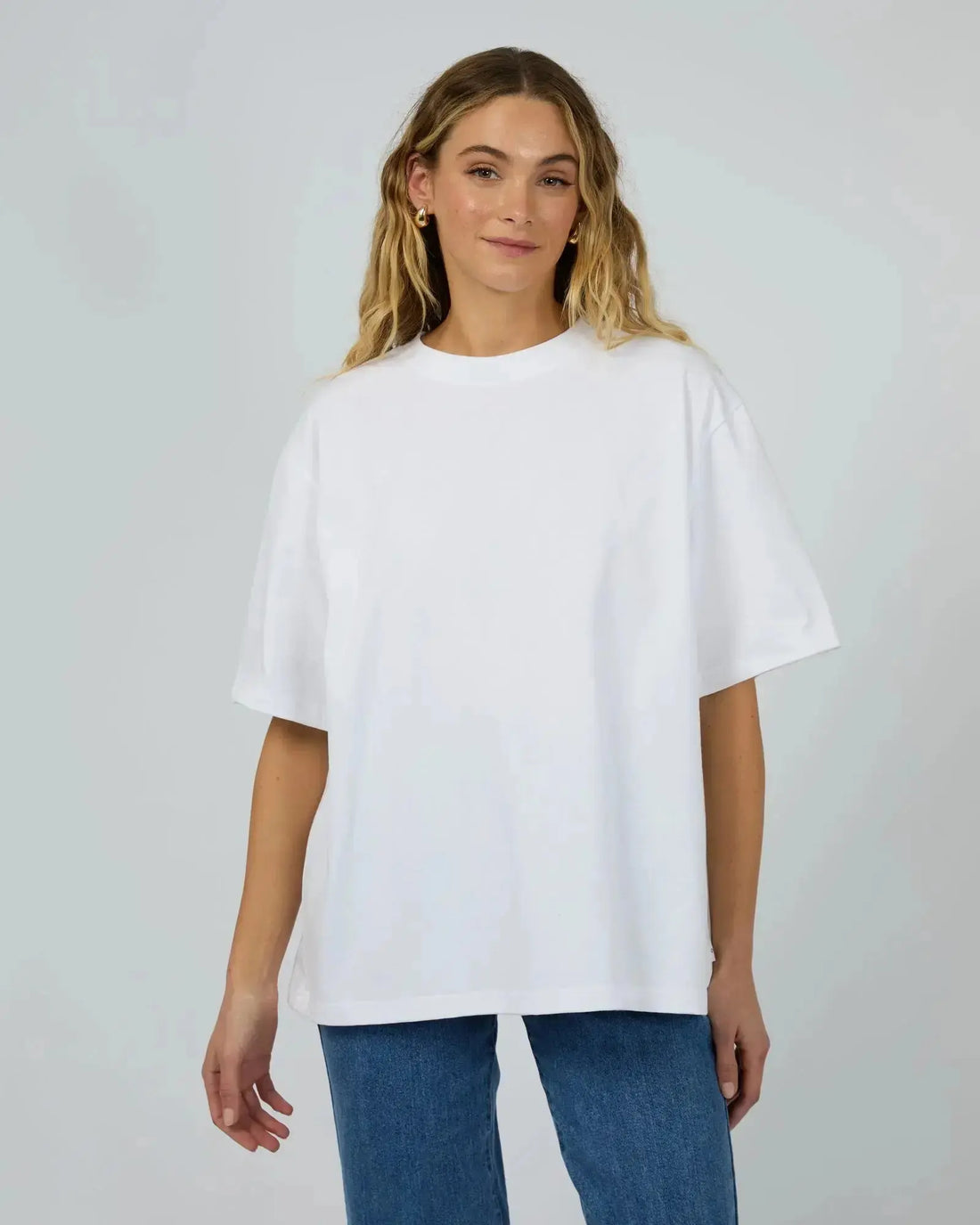 Woman wearing a white oversized tee — timeless wardrobe staples from The Rose Edit NZ