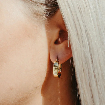 Gold Aria Hoop earring worn on model — close-up ear shot