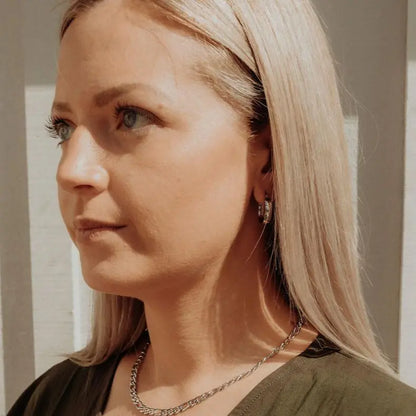 Model wearing gold Aria Hoops and chain necklace — three-quarter face shot