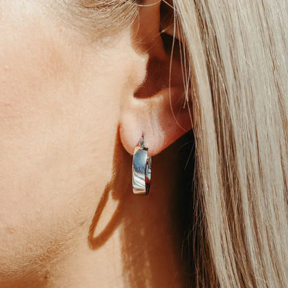 Silver Aria Hoop earring worn on model — close-up ear shot in natural light