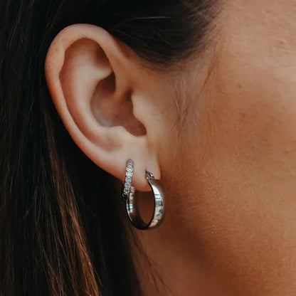 Silver Aria Hoop stacked with crystal pave huggie on model — close-up ear shot