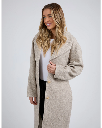 Woman wearing a beige coat on a white background