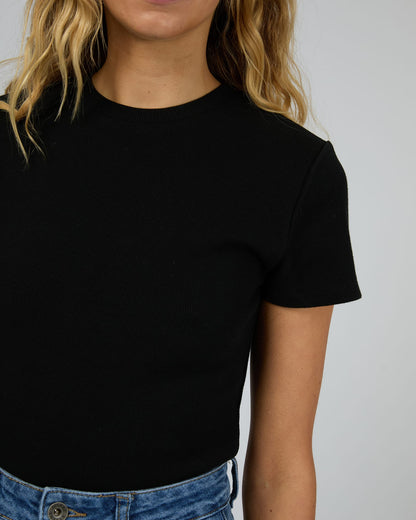 Person wearing a black t-shirt against a plain background