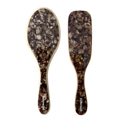 Two wooden hairbrushes with tortoiseshell pattern on a white background. 