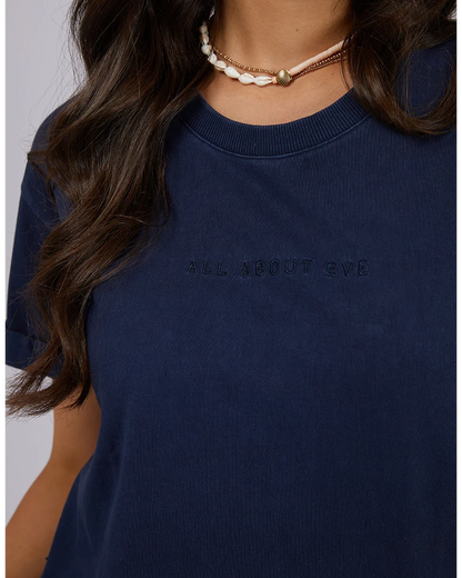 Navy blue t-shirt with 'All About Eve' branding worn by a person.