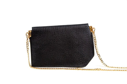 Black handbag with a gold chain strap on a white background
