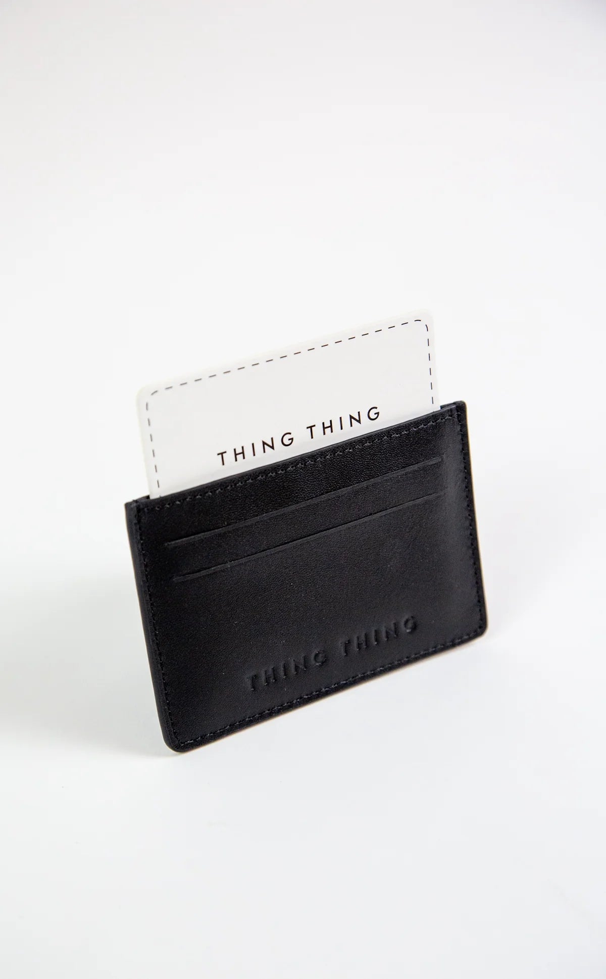 Black cardholder with 'THING THING' branding on a white background