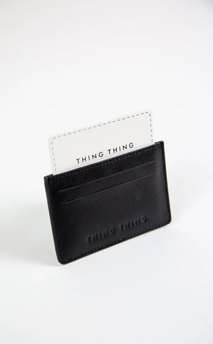 Black cardholder with 'THING THING' branding on a white background