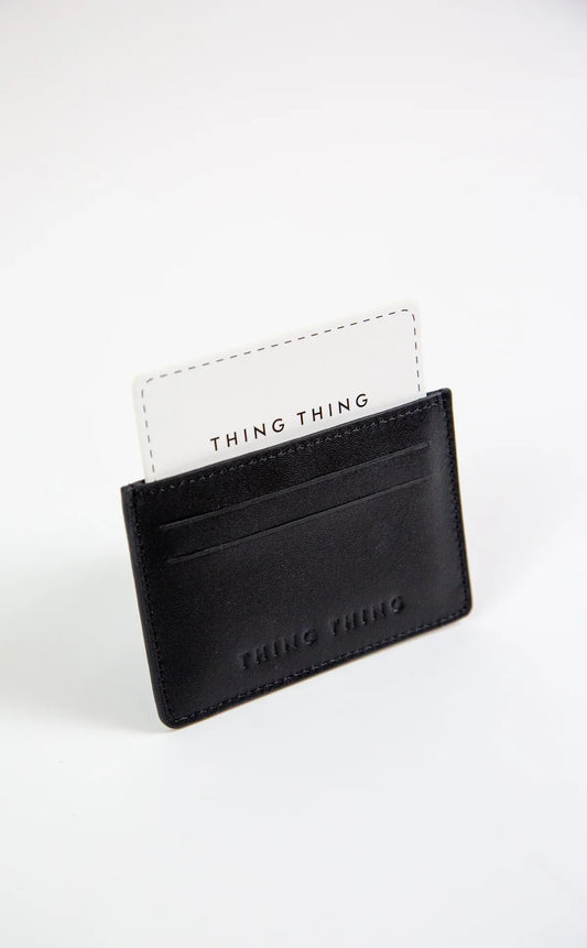 Black cardholder with 'THING THING' branding on a white background