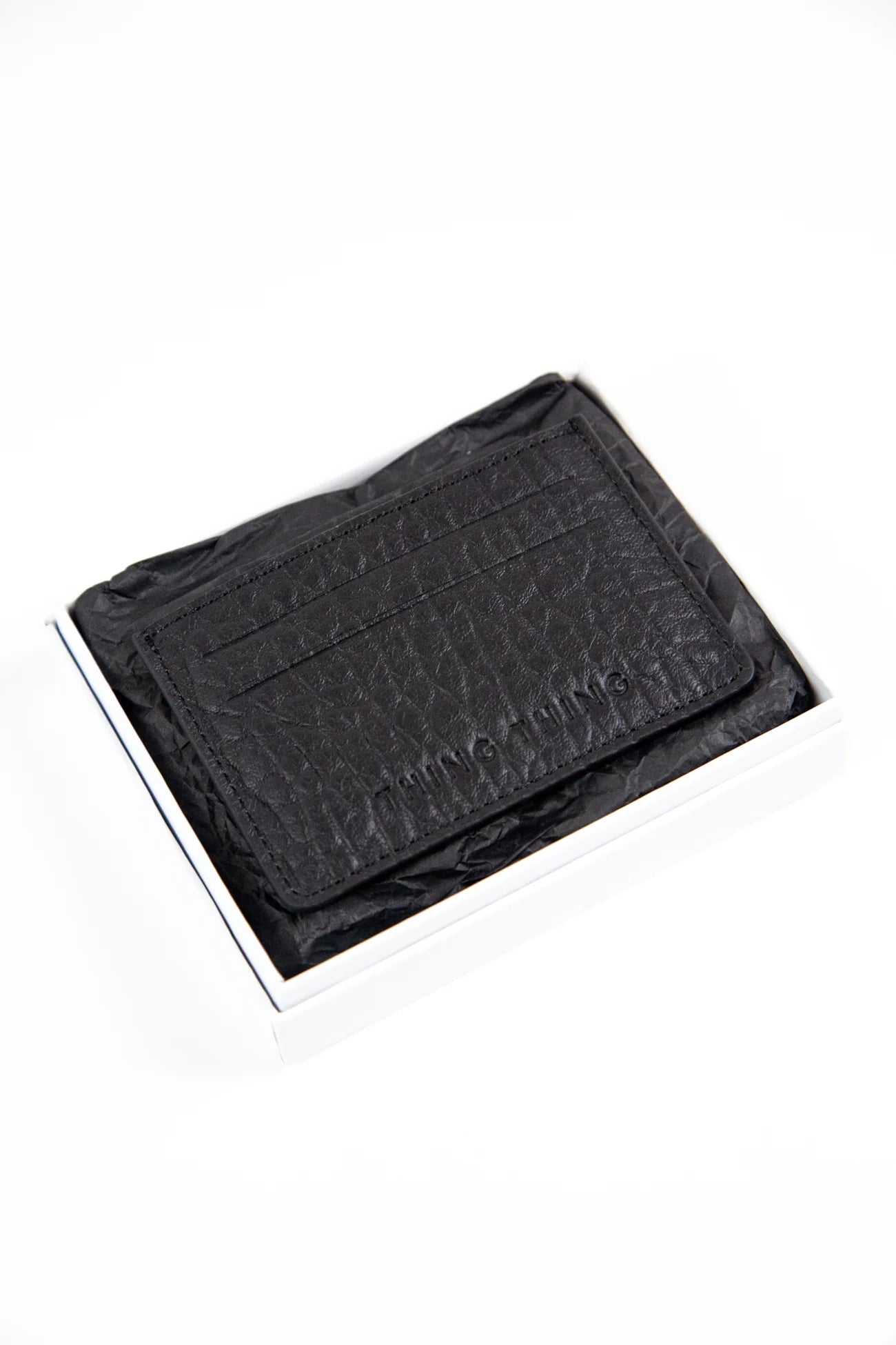 Black textured wallet on a white background
