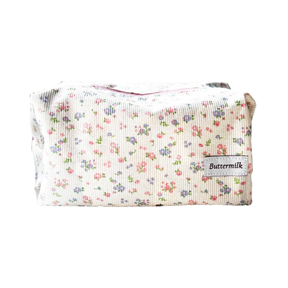 Floral-patterned pouch with 'Buttermilk' label on a white background. Buttermilk Grace Carry All Bag Forget-Me-Not - The Rose Edit