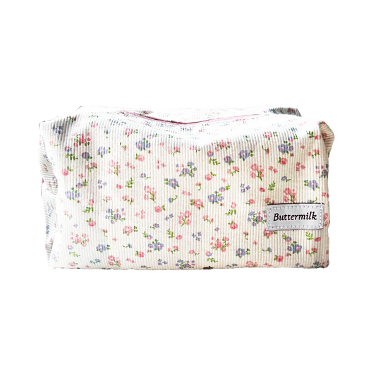 Floral-patterned pouch with 'Buttermilk' label on a white background. Buttermilk Grace Carry All Bag Forget-Me-Not - The Rose Edit