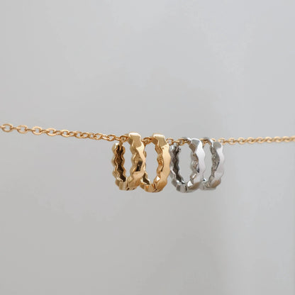 Gold and silver necklace with interlocking rings on a light gray background. Mini Hex Hoop Earrings KatyB Jewellery