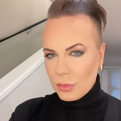 Woman with styled hair and makeup wearing a black turtleneck in an indoor setting. The Perfect Huggies Diamond - The Rose Edit