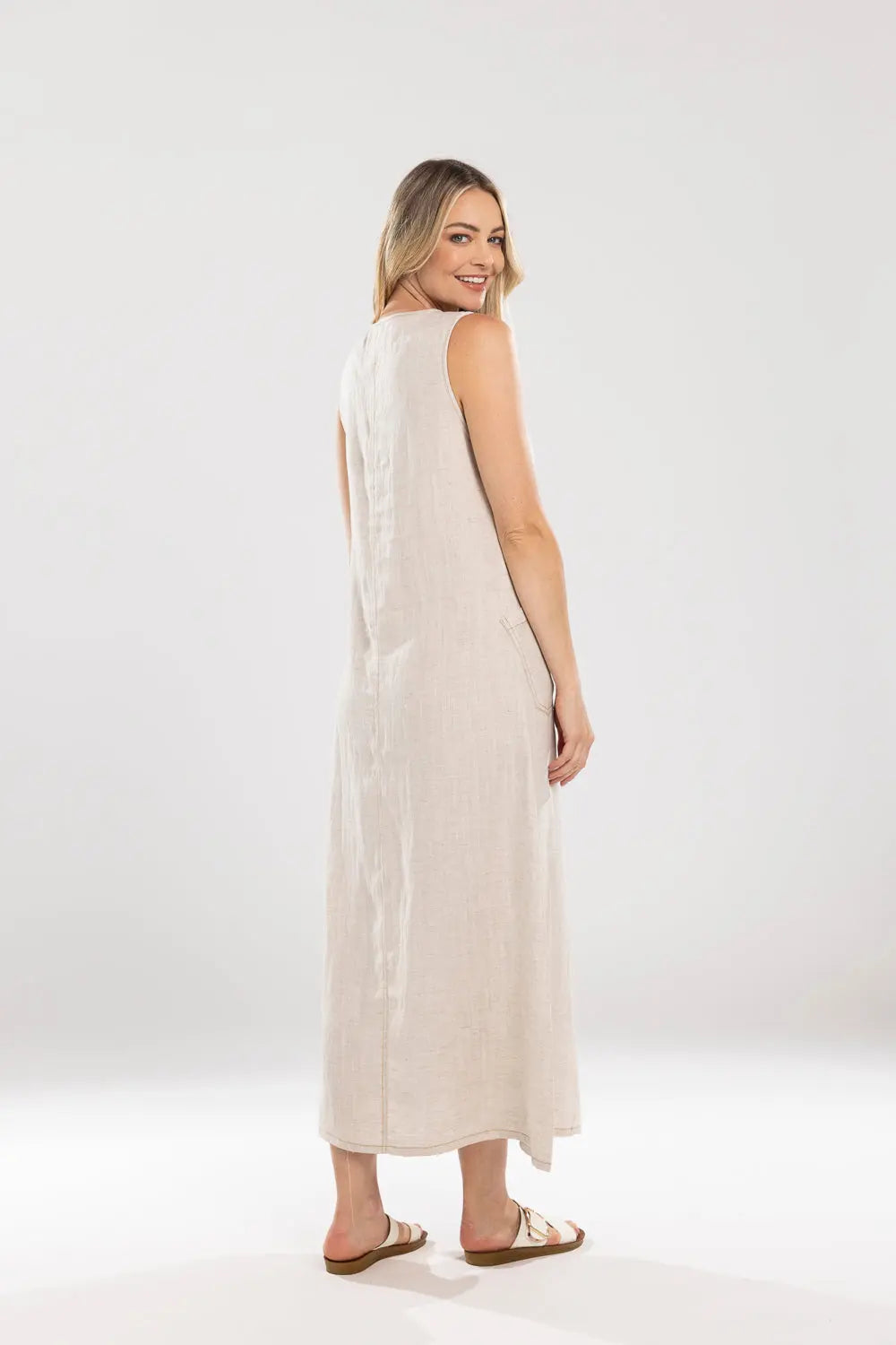 Woman wearing a white sleeveless dress on a white background