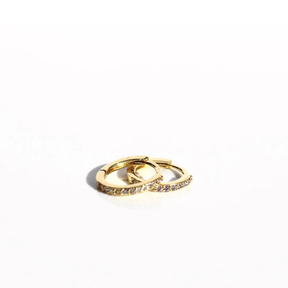 Gold ring with embedded stones on a white background. Petite Sleepers Fine - The Rose Edit