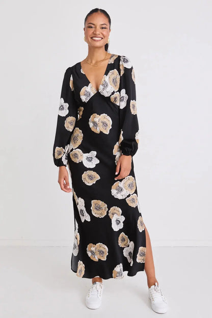 Woman wearing a black floral dress on a white background