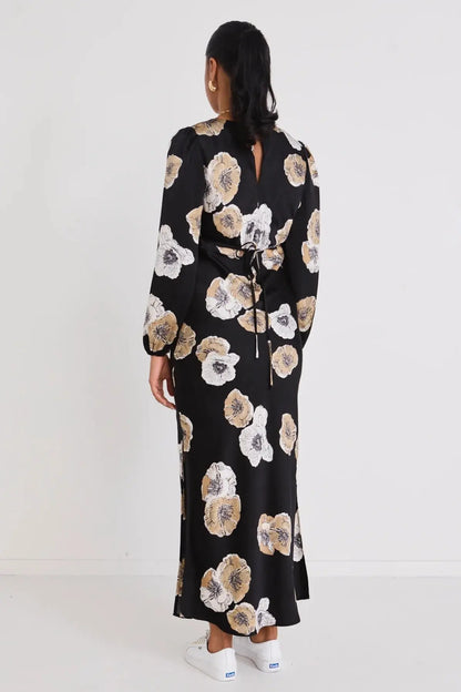 Woman wearing a black floral dress on a white background