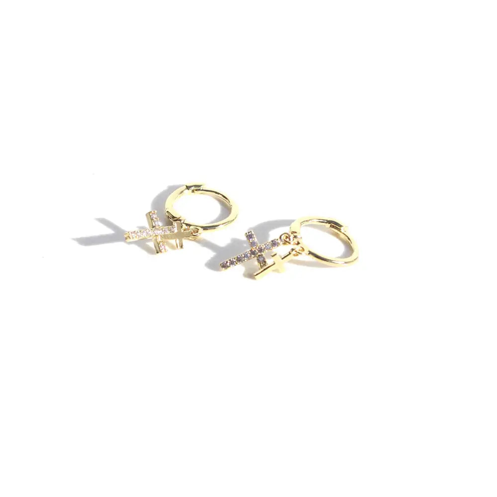 Gold hoop earrings with star and cross charms on a white background