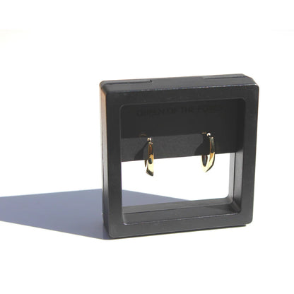 Black earring display stand with gold earrings on a white background