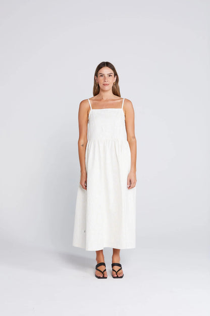 Woman wearing a white dress on a light gray background