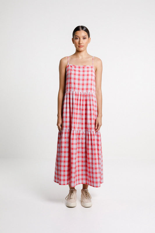 Woman wearing a red and white checkered dress on a white background