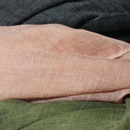 Close-up of fabric with a textured pattern in shades of brown, green, and black.