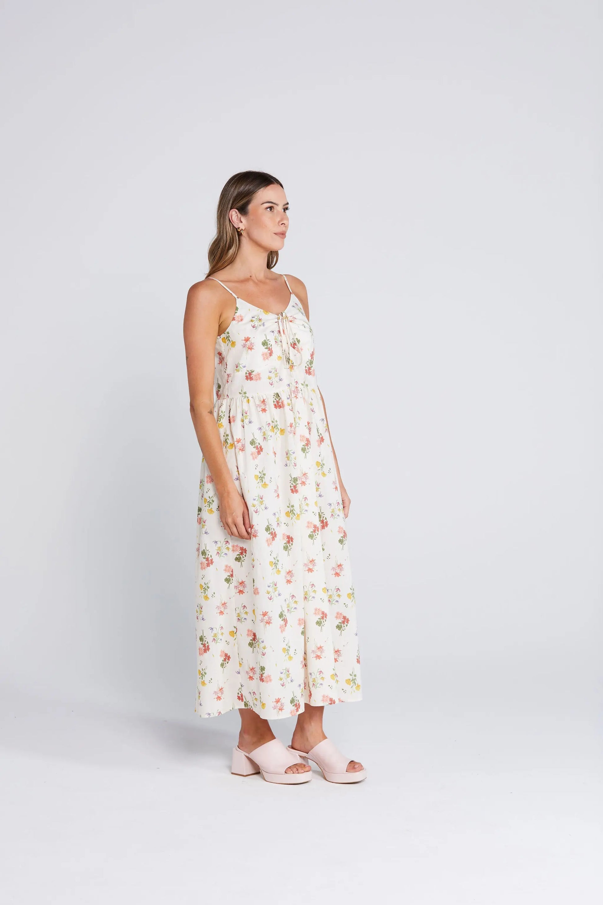 Woman wearing a floral dress on a white background